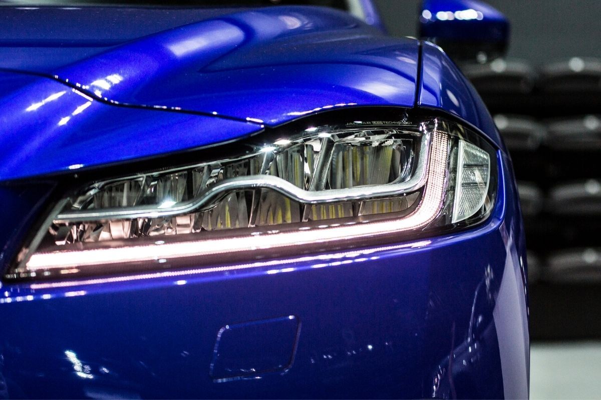 Blue car with HID headlight at the garage