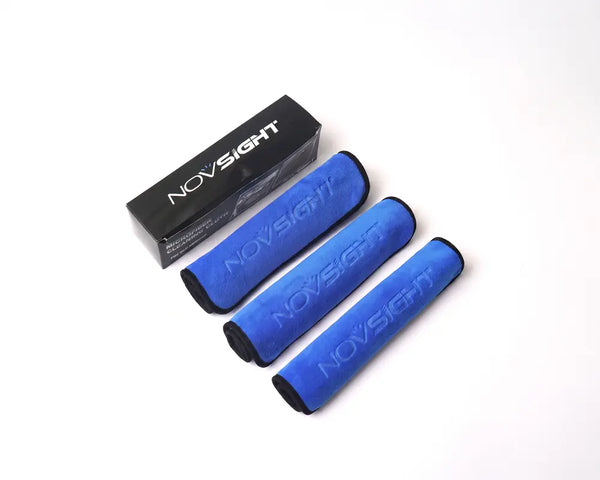 Four blue Novsight grip tape rolls with black edges arranged diagonally next to a black Novsight product box on a white background.